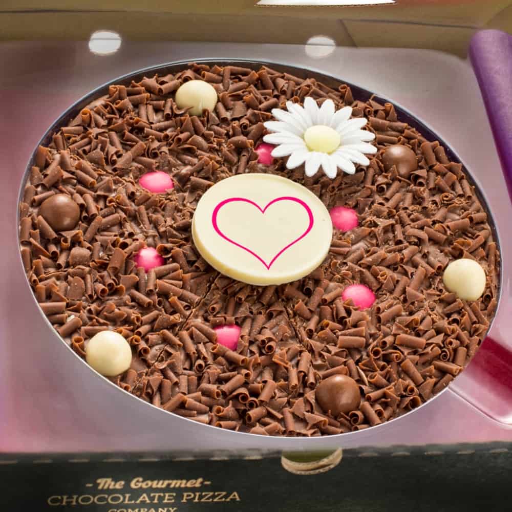 Our Spring-themed Flower Chocolate Pizza sees milk chocolate curls, milk and white chocolate rice balls and pink rainbow chocolate drops nestled on a solid milk chocolate base, with a wafer daisy in the centre.